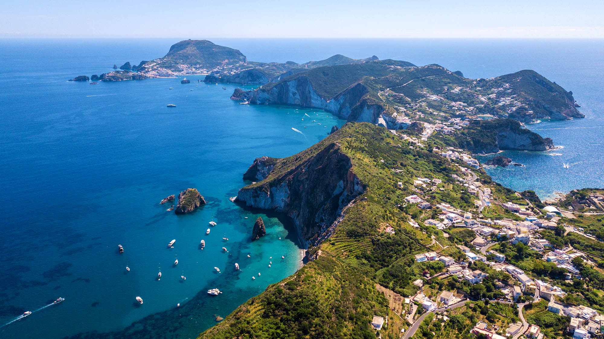 Aerial view of Ponza, island of the Italian Pontine Islands archipelago in the Tyrrhenian Sea, Italy. On the island there are few houses between the Mediterranean vegetation and the sea.